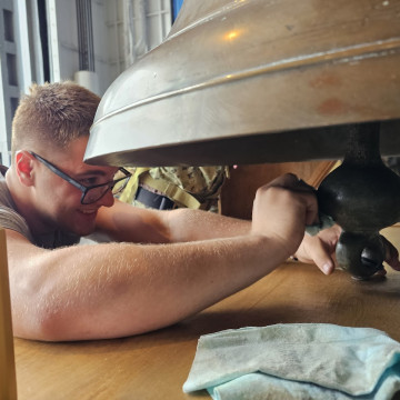 Polishing the ship's Bell